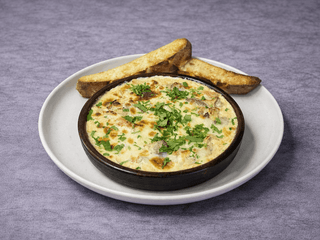 Рапани в вершковому соусі