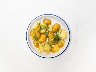 Young boiled potatoes with butter, garlic, and dill