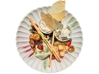Assortie of finest cheeses. marinated feta, parmesan, chevre in pistachio crust,  truffle cream cheese and gorgonzola. Served with berries, nuts and crispy grissini