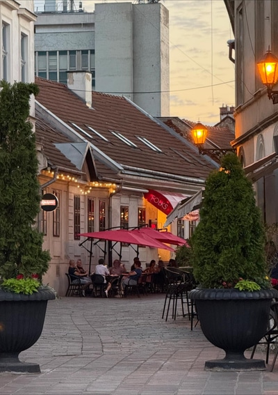 Folks on Vrátna in Košice, with outdoor seating