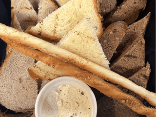 Bread basket with truffle oil and grisini