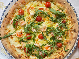 Pizza with tiger prawns and arugula