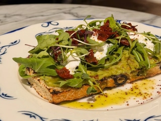 Focaccia with avocado, stracciatella and sun-dried tomatoes