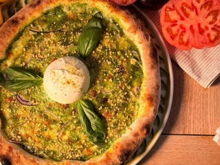 Pizza with green pesto, burrata, and pistachios