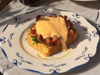 Eggs Benedict with hollandaise sauce and bacon 