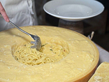 Spaghetti cooked in a head of parmesan cheese aged 24 months