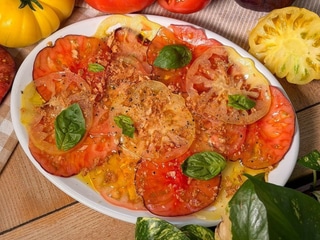 Multicolored tomato carpaccio with basil