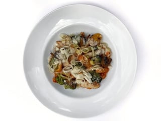 Pasta with chicken and vegetables in tomato and cream sauce