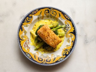 Salmon with baked vegetables, asparagus and cheese sauce