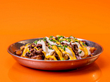Loaded potato wedges with minced meat and cheese