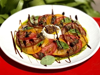 Tomates anciennes, mousse  Carpaccio de tomates anciennes, mousse  de fromage de chèvre, pesto au basilic et anchois